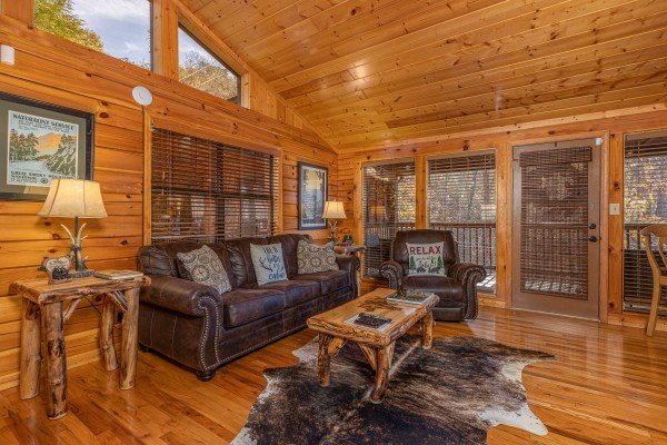 Sofa and chair in the living room at Close at Heart, a 1 bedroom cabin rental located in Pigeon Forge