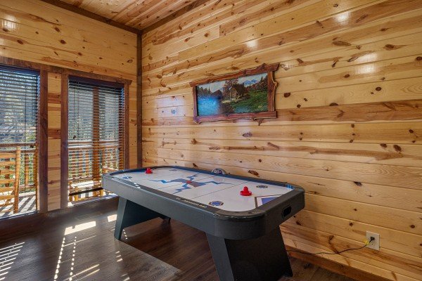 Air hockey at Mountain Joy, an 8 bedroom cabin rental located in Pigeon Forge