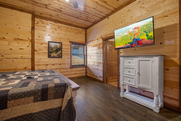 Bedroom tv and dresser at Mountain Joy, an 8 bedroom cabin rental located in Pigeon Forge