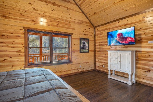 King bedroom flat screen at Mountain Joy, an 8 bedroom cabin rental located in Pigeon Forge