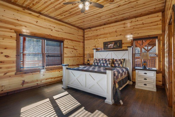 King bed and bedside table at Mountain Joy, an 8 bedroom cabin rental located in Pigeon Forge