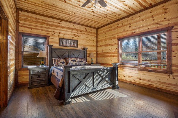 King bedroom with bedside table at Mountain Joy, an 8 bedroom cabin rental located in Pigeon Forge