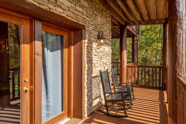 Deck with rocking chairs at Grizzly's Den, a 5 bedroom cabin rental located in Gatlinburg
