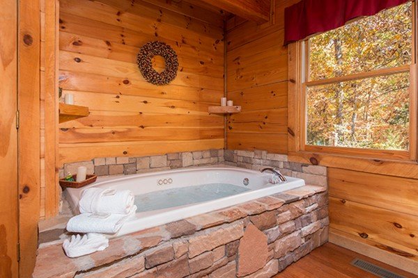 Jacuzzi at Bear Hug Hideaway, a 1-bedroom cabin rental located in Pigeon Forge