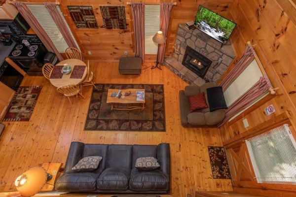 Looking down into the living room at Swept Away in the Smokies, a 1 bedroom cabin rental located in Pigeon Forge