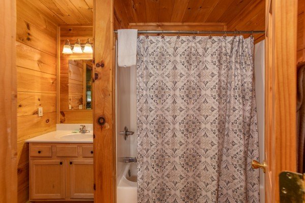 Bathroom with a tub and shower at Swept Away in the Smokies, a 1 bedroom cabin rental located in Pigeon Forge