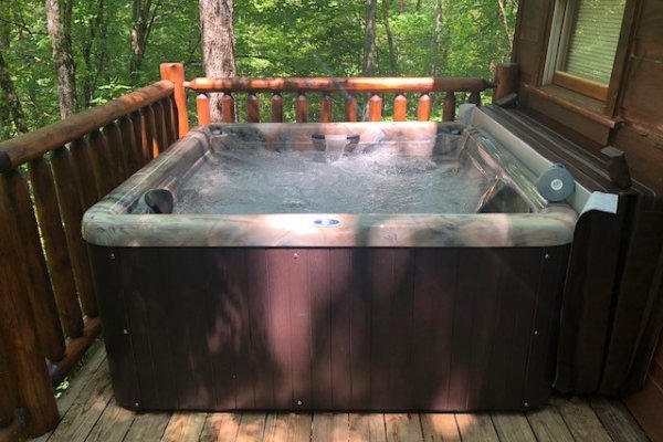 A new hot tub on the deck at Swept Away in the Smokies, a 1 bedroom cabin rental located in Pigeon Forge