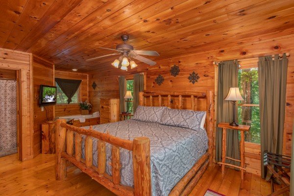 Bedroom with a king log bed at Swept Away in the Smokies, a 1 bedroom cabin rental located in Pigeon Forge