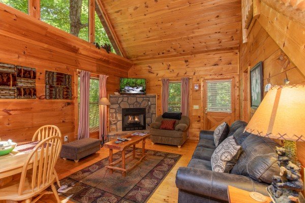 Living room with fireplace and TV at Swept Away in the Smokies, a 1 bedroom cabin rental located in Pigeon Forge 