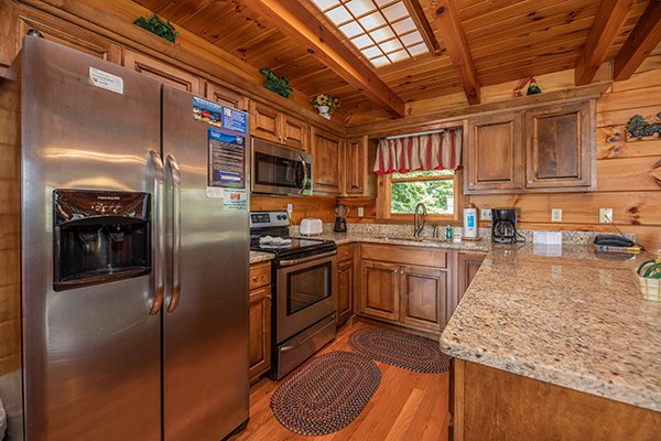 Kitchen with granite counters and stainless appliances at Eagles View Lodge, a 3 bedroom cabin rental located in Gatlinburg