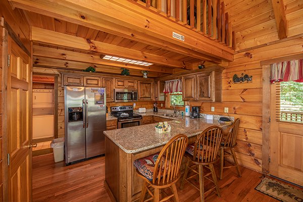 Breakfast bar with granite counters and stainless appliances at Eagles View Lodge, a 3 bedroom cabin rental located in Gatlinburg