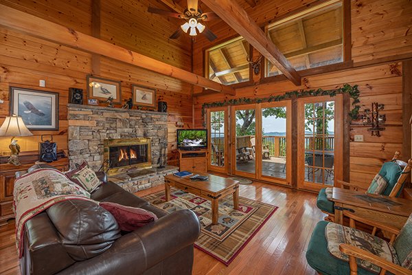 Living room with fireplace & tv at Eagles View Lodge, a 3 bedroom cabin rental located in Gatlinburg