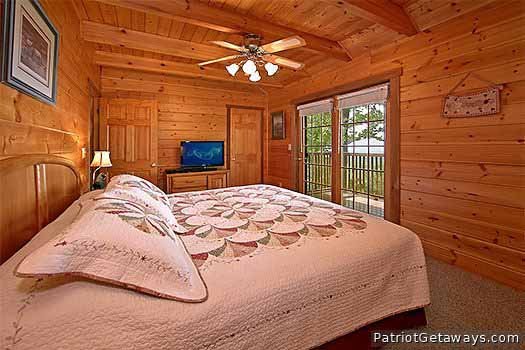 Second floor king sized bed in bedroom at Eagle's View Lodge, a 3-bedroom cabin rental located in Gatlinburg