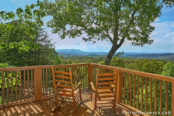 Two rocking chairs on the deck, overlooking the Smoky Mountains at Eagle's View Lodge, a 3-bedroom cabin rental located in Gatlinburg