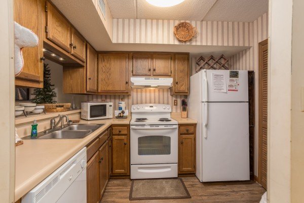 Kitchen with white appliances at High Alpine #204, a 2 bedroom cabin rental located in Gatlinburg