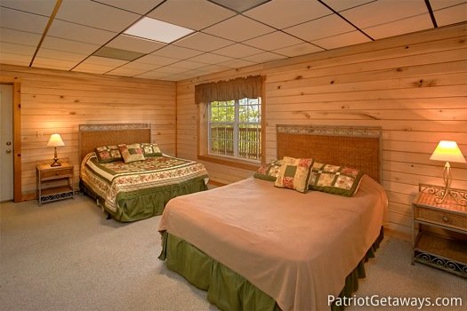 First floor bedroom with two queen beds at On Angels Wings, a 5 bedroom cabin rental located in Gatlinburg