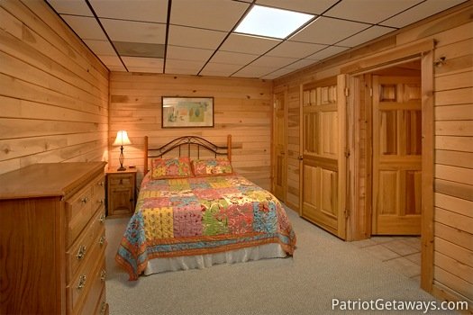 First floor bedroom with single queen bed at On Angels Wings, a 5 bedroom cabin rental located in Gatlinburg