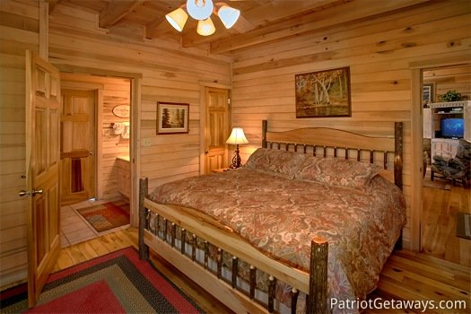 Main level bedroom with queen bed at On Angels Wings, a 5 bedroom cabin rental located in Gatlinburg