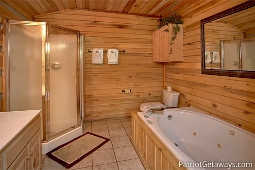 Jacuzzi tub and corner shower in the third floor bathroom at On Angels Wings, a 5 bedroom cabin rental located in Gatlinburg