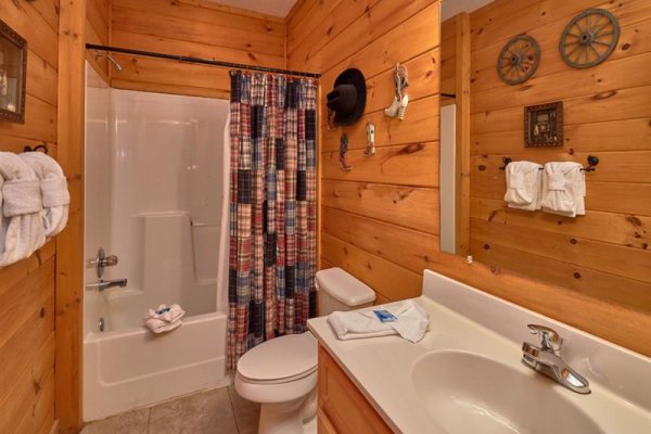 Bathroom with tub and shower at Wagon Wheel Cabin, a 3 bedroom cabin rental located in Pigeon Forge