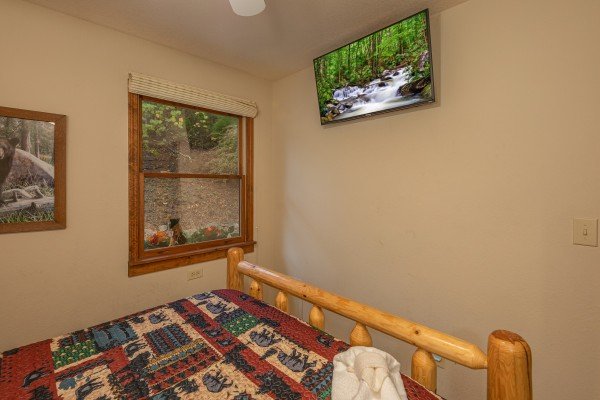 Wall mounted TV in a bedroom at Lazy Bear Retreat, a 4 bedroom cabin rental located in Pigeon Forge