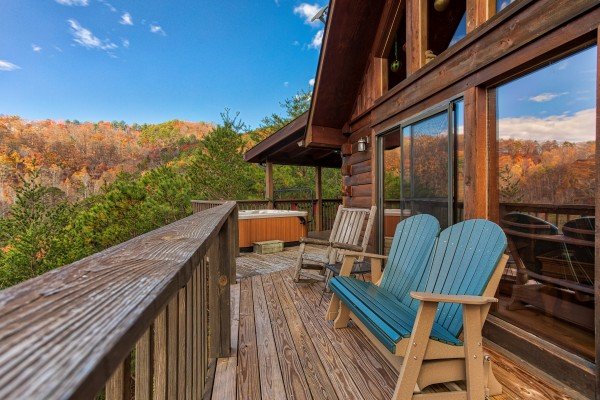 Adirondack bench and chair on a deck at R & R Hideaway, a 1 bedroom cabin rental located in Pigeon Forge