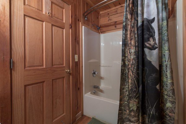 Bathroom with a tub and shower at R & R Hideaway, a 1 bedroom cabin rental located in Pigeon Forge
