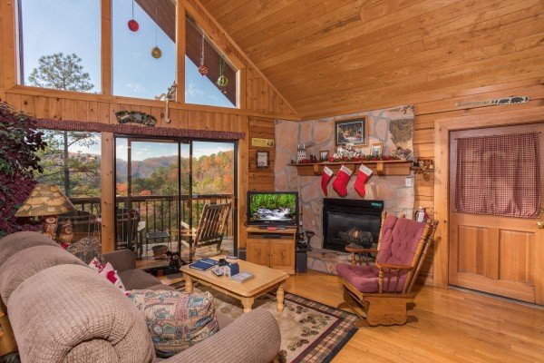 Fireplace, TV, and mountain views in the living room at R & R Hideaway, a 1 bedroom cabin rental located in Pigeon Forge
