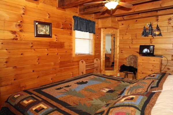 Bedroom with dresser and television at Bear's Lair, a 2-bedroom cabin rental located in Pigeon Forge