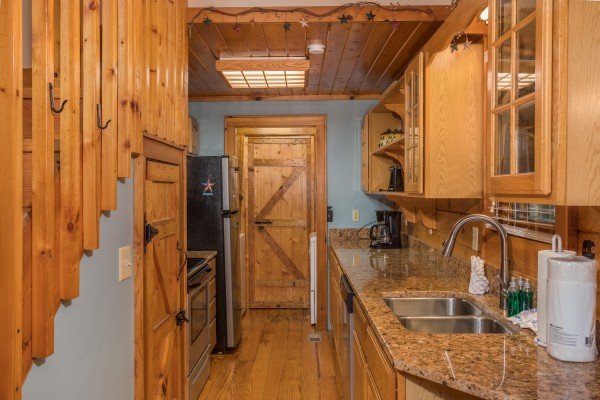 Galley kitchen with stainless appliances at Bear's Lair, a 2-bedroom cabin rental located in Pigeon Forge