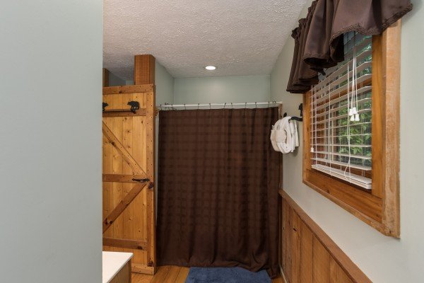 Bathroom with a tub and shower at Bear's Lair, a 2-bedroom cabin rental located in Pigeon Forge