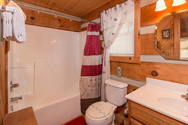 Bathroom with tub and shower at Bare Hugs, a 1-bedroom cabin rental located in Pigeon Forge