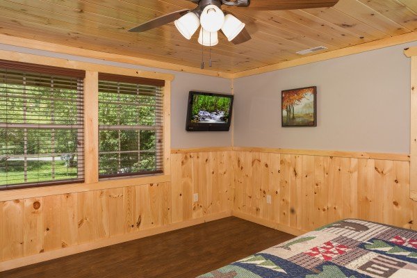 King bedroom with a TV at Grill & Chill, a 2-bedroom Gatlinburg cabin rental