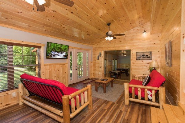 Two futons and a TV in the living room at Grill & Chill, a 2-bedroom Gatlinburg cabin rental