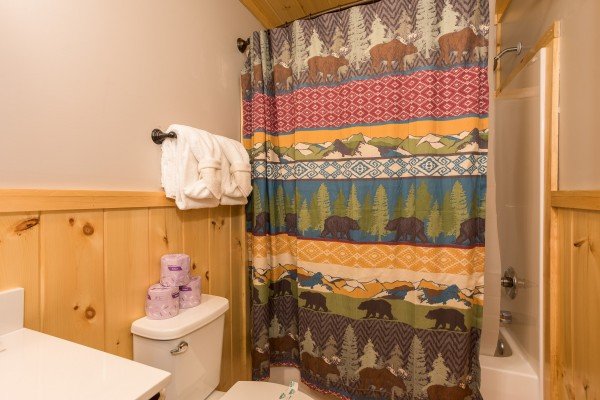 Bathroom with a tub and shower at Grill & Chill, a 2-bedroom Gatlinburg cabin rental