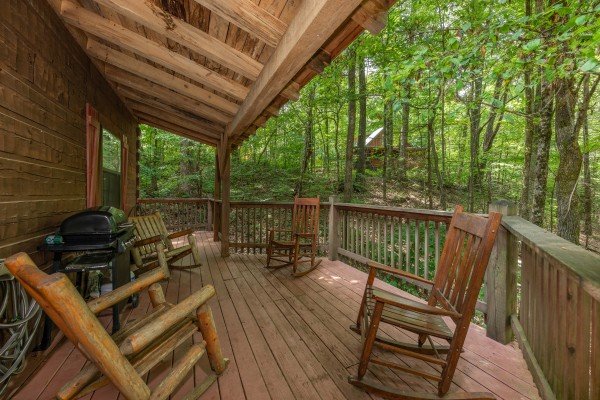 Rocking chairs on a covered deck at Cabin on the Mountain, a 2 bedroom cabin rental located in Gatlinburg