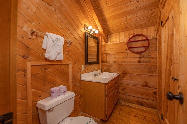 Bathroom sink and toilet at Cabin on the Mountain, a 2 bedroom cabin rental located in Gatlinburg