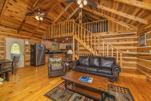 Sofa and chair in a living room at Bootlegger Hill Hideaway, a 2 bedroom cabin rental located in Pigeon Forge