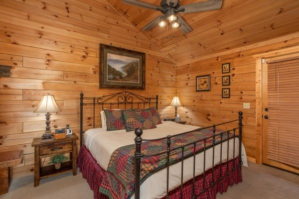 King bed and two nightstands at Fowl Play, a 1 bedroom cabin rental located in Pigeon Forge