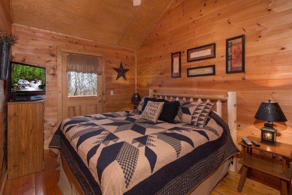 Bedroom with a dresser, TV and deck access at Sunny Side Up, a 2 bedroom cabin rental located in Gatlinburg