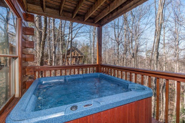 Hot tub on a covered porch at Sunny Side Up, a 2 bedroom cabin rental located in Gatlinburg