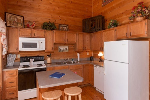 Kitchen with white appliances at Sunny Side Up, a 2 bedroom cabin rental located in Gatlinburg