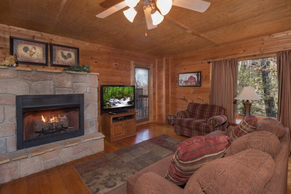 Living room with fireplace and TV at Sunny Side Up, a 2 bedroom cabin rental located in Gatlinburg