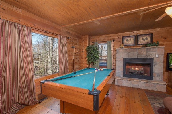 Pool table in the living room at Sunny Side Up, a 2 bedroom cabin rental located in Gatlinburg