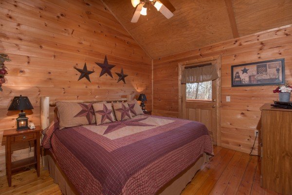 Bedroom with a king bed, dresser, and deck access at Sunny Side Up, a 2 bedroom cabin rental located in Gatlinburg