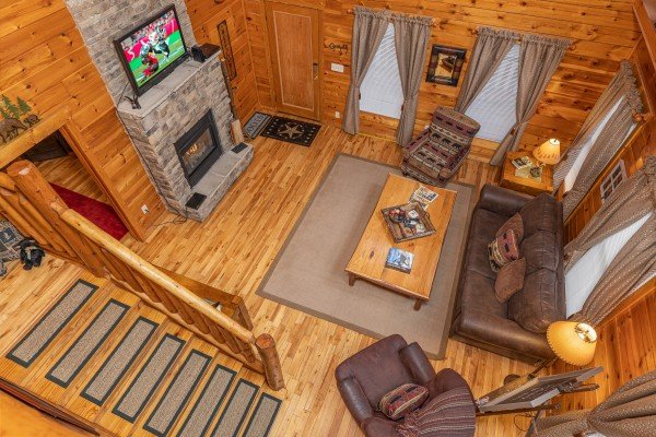 Looking down at the living room from the upper floor at Whispering Grace, a 2 bedroom cabin rental located in Gatlinburg
