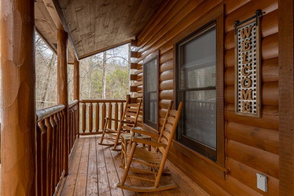 Rocking chairs on the porch at Whispering Grace, a 2 bedroom cabin rental located in Gatlinburg