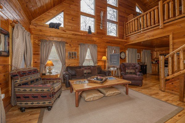 Vaulted living room with sofa, loveseat, and chair at Whispering Grace, a 2 bedroom cabin rental located in Gatlinburg