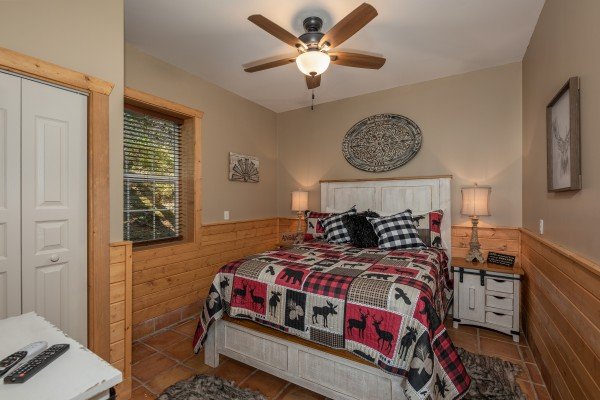 Bedroom with rustic furniture at Hawk’s Heart Lodge, a 3 bedroom cabin rental located in Pigeon Forge