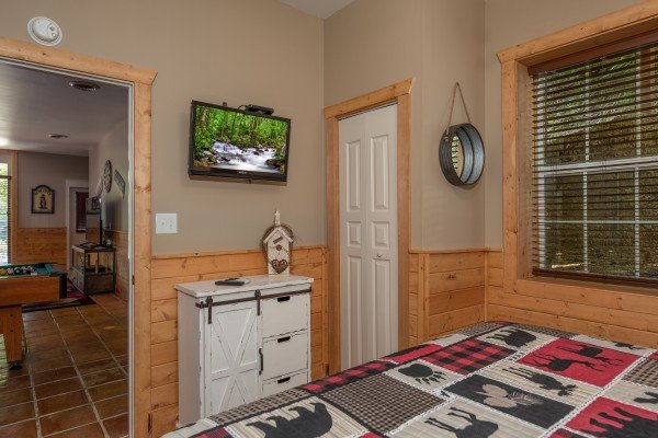 Dresser and TV in a bedroom at Hawk’s Heart Lodge, a 3 bedroom cabin rental located in Pigeon Forge